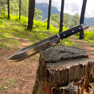 11 inch hand-forged bowie knife in wooden log